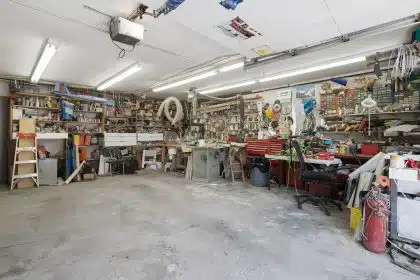 a garage filled with lots of clutter and tools