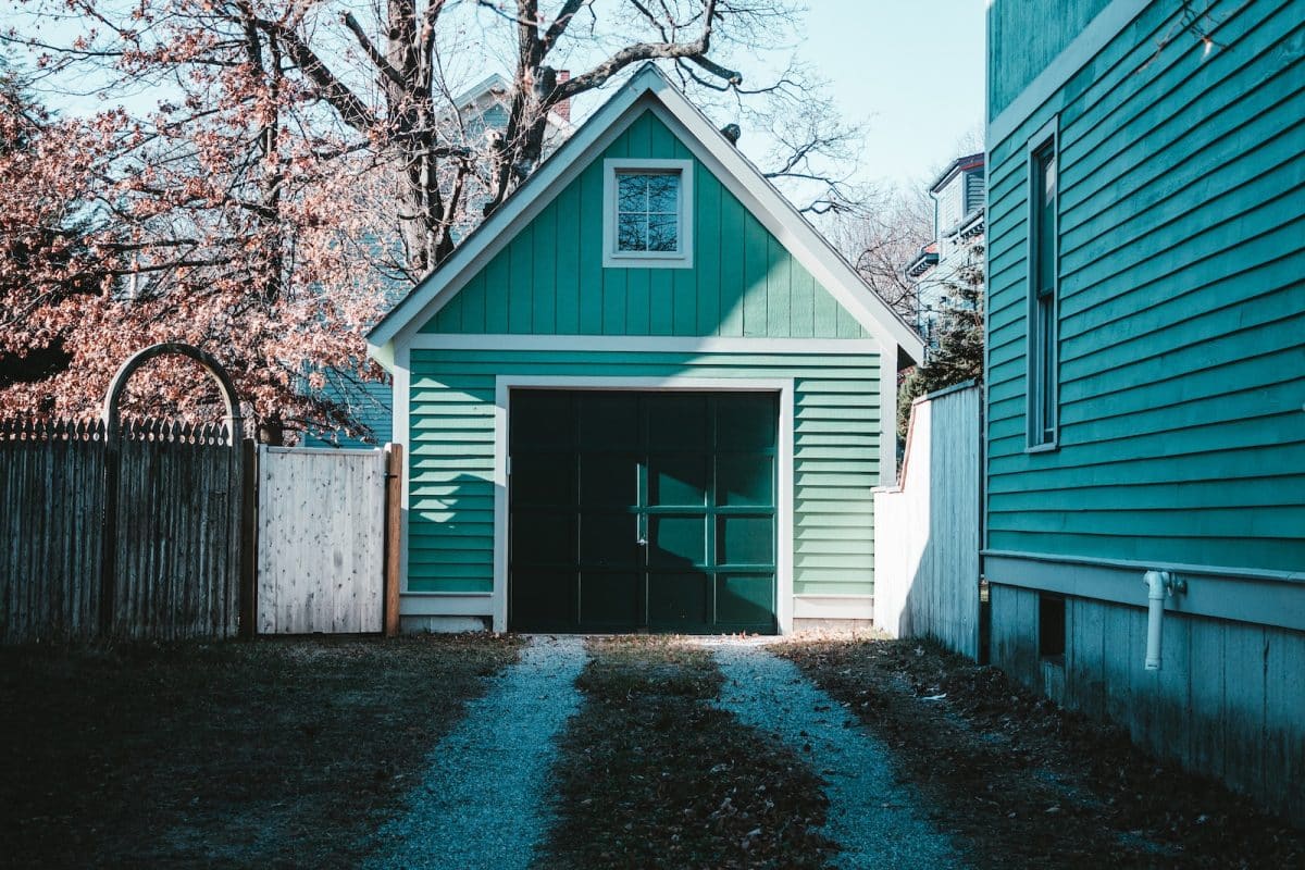 blue and white wooden house near brown trees during daytime